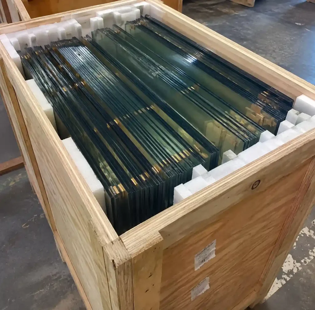 Glass panels loaded vertically in crate with foam edge protection