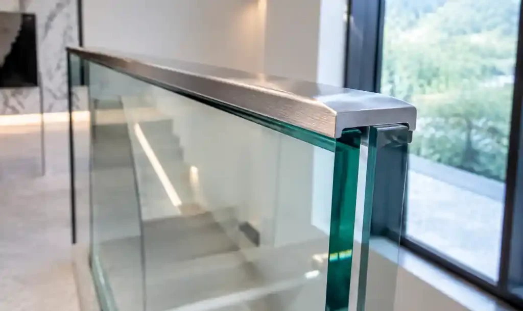 Polished edge protection detail on commercial glass handrail installation